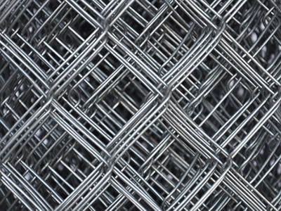 A detail of diamond meshes of galvanized chain link fence.