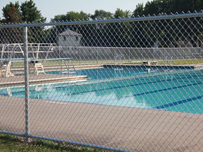 This is a empty swimming pool with chain link mesh as pool fencing.