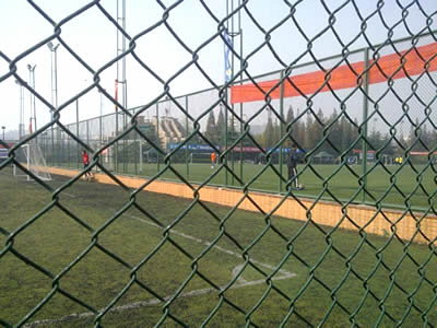There is green PVC coated chain link fence for football field fencing.