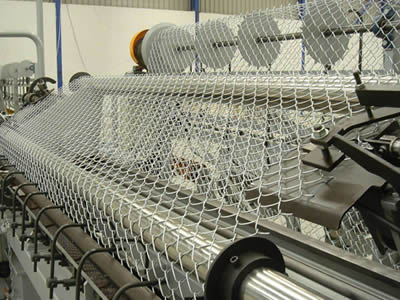 Chain link fence is produced by a fully automatic machine.