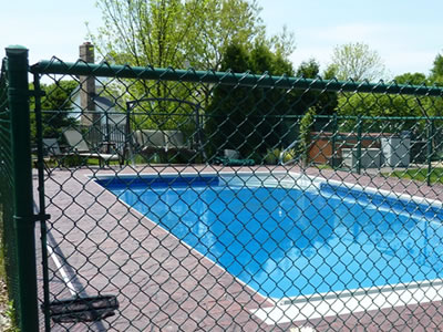 This is a small family used swimming pool, it is surrounded with chain link fence for protection.