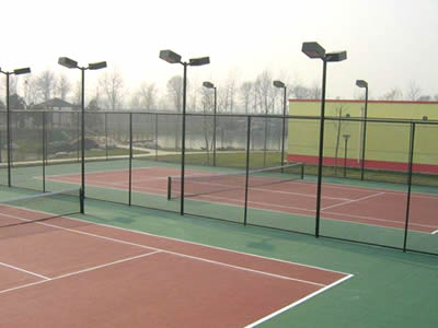 There is green chain link fence for tennis court fencing.