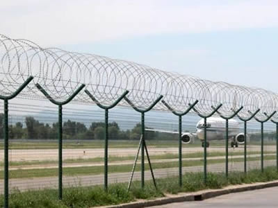 Concertina razor barbed wire is installed on the top of airport welded fence.