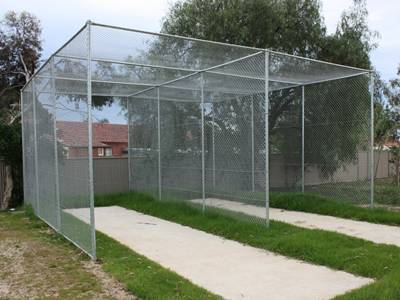 Aluminum-coated chain link fabric cricket net fence enclosures on the grassland.