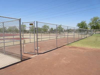 Zinc coated chain link fencing and gate in the blue sky.