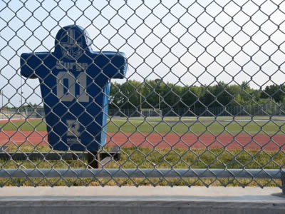 A galvanized chain link football fence is installed at a stadium.