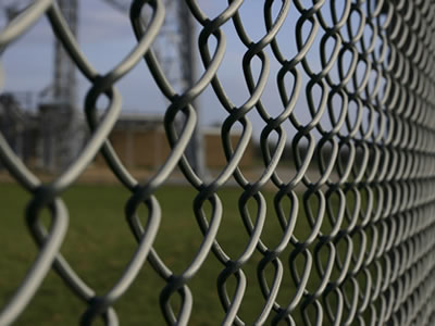 Rigid chain link fabric mesh is used as fencing for cricket.