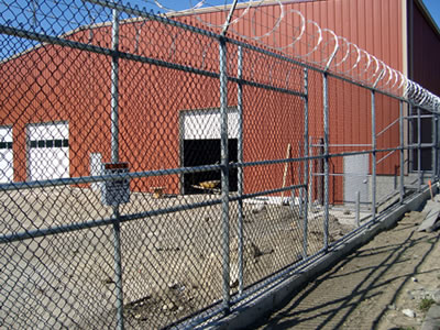 This is a chain link fabric mesh fencing that is used in a warehouse.